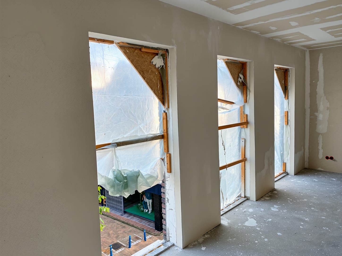 Plastered reveals around a window frame during a renovation